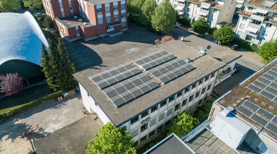 Ein Flachdach mit Solarpanels aus der Vogelperspektive.